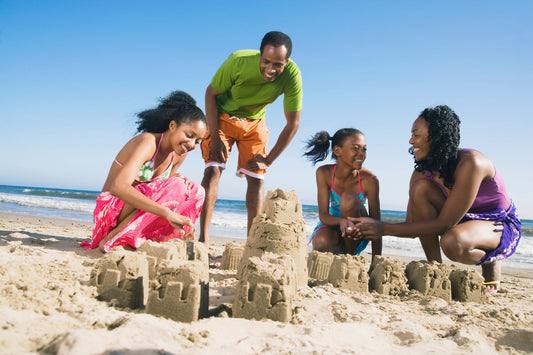 Family building a sand castle on the beach in Australia